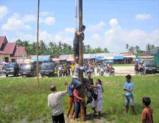 Puluhan Pedagang Adakan Lomba Panjat Pinang